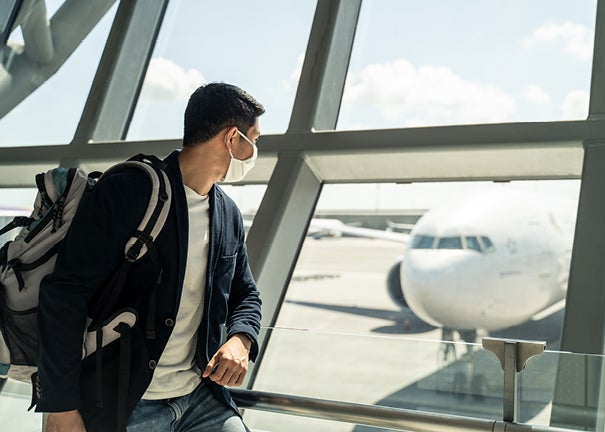 Man looking at plane in airport
