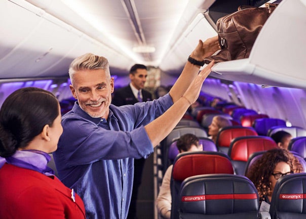 Man talking to flight attendant