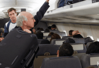 Man-stuffing-bag-into-plane