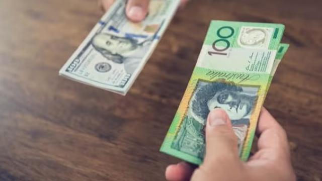 Hand holding Australian dollars getting ready to pay on an overseas trip. 
