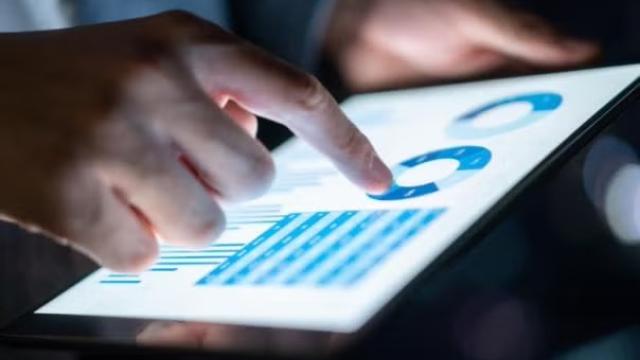 Hand holding a tablet representing Flight Centre Travel Group end of financial year results – 2021/2022
