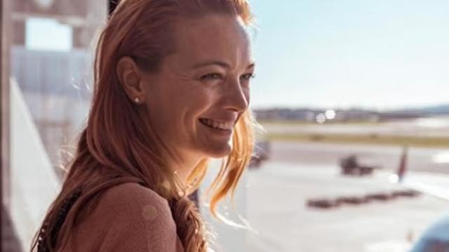 Woman looking out the window at the airport representing the importance of a corporate travel partner.
