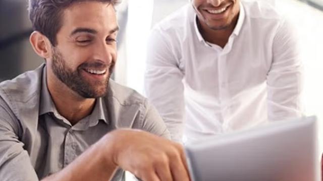Co-workers looking at a document demonstrating why a company should never compromise on great service