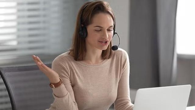Woman talking on the phone demonstrating how virtual travel assistant adds human touch to Savi.
