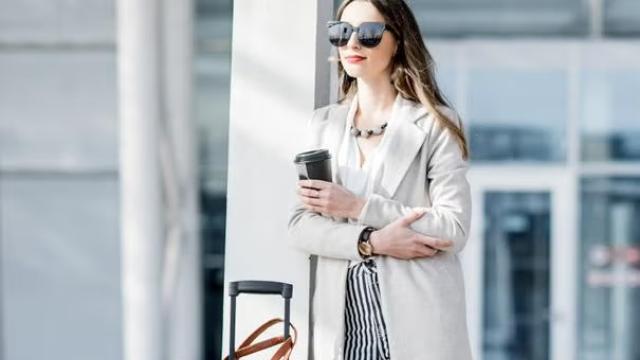 Woman waiting outside an airport highlighting the top holiday hacks for 2025