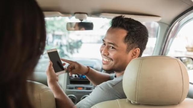 Uber driving talking to a passenger. 
