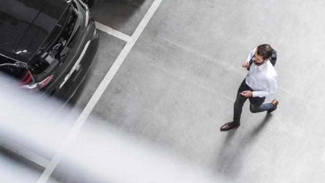 Man walking in a parking garage highlighting the rise of bleisure travel among gen z