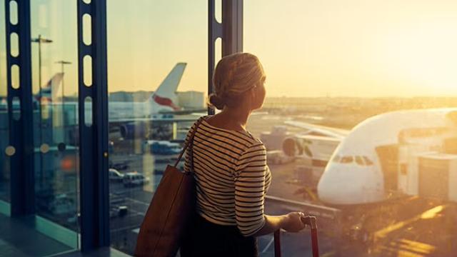 Women looking out of airport window representing mistakes your business should avoid when booking travel.