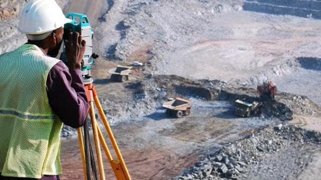 Man at a mining site, showcasing regional travel and the mining industry's need for seamless business travel solutions.