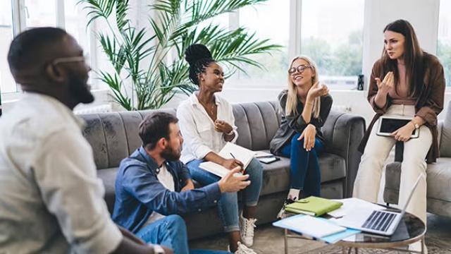 Group in a casual meeting, representing remote and hybrid workers collaborating at offsite events.