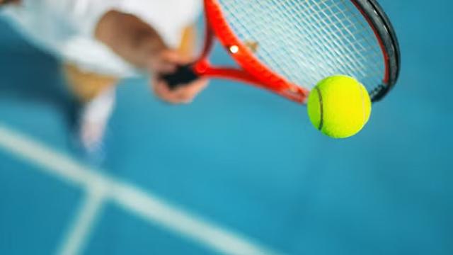 A tennis player hitting a ball, symbolising the Australian Open and emerging travel trends around major sporting events.