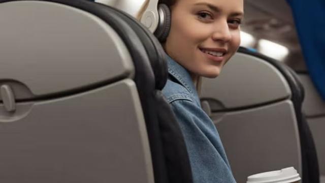 Woman holding a coffee enjoying her airline seat Man enjoying his airline seat Man working from an airline seat representing the perks of getting the best seats on the plane.