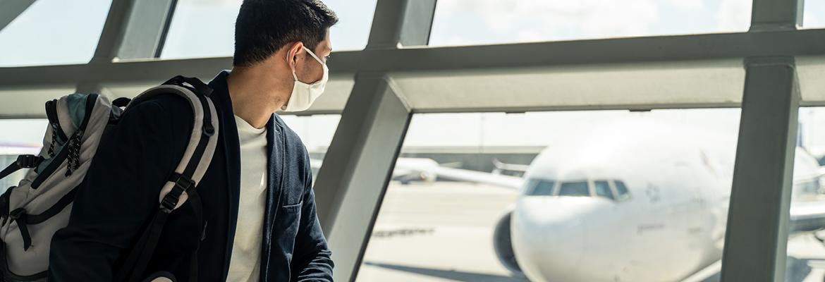 Man looking at plane in airport