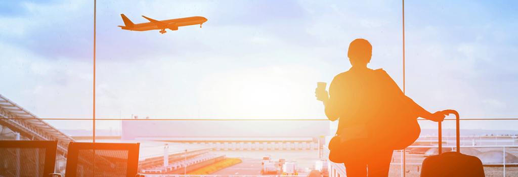 Passenger in terminal watching Jetstar Plane