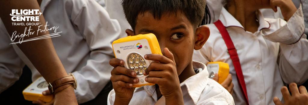 Child holding SolarBuddy light