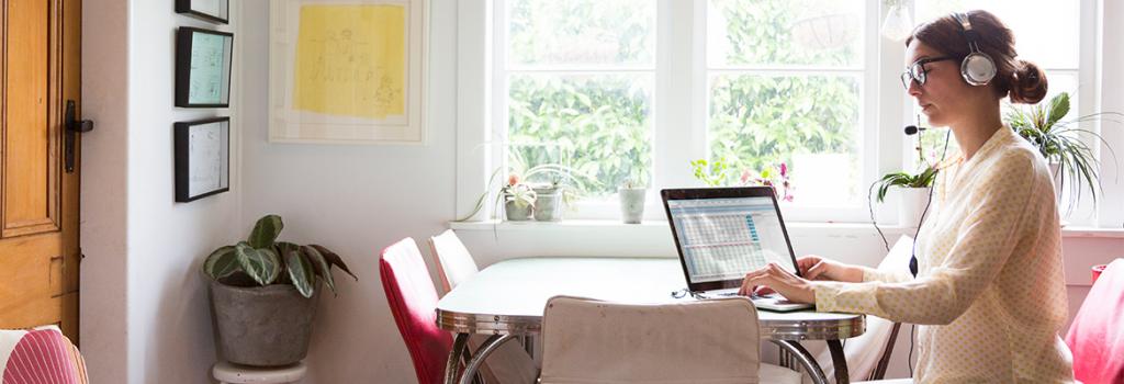 Lady working in at home near window