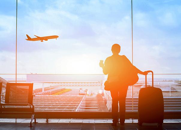 Passenger in terminal watching Jetstar plane