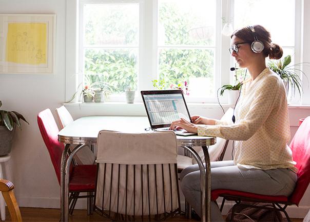 Lady working in at home near window