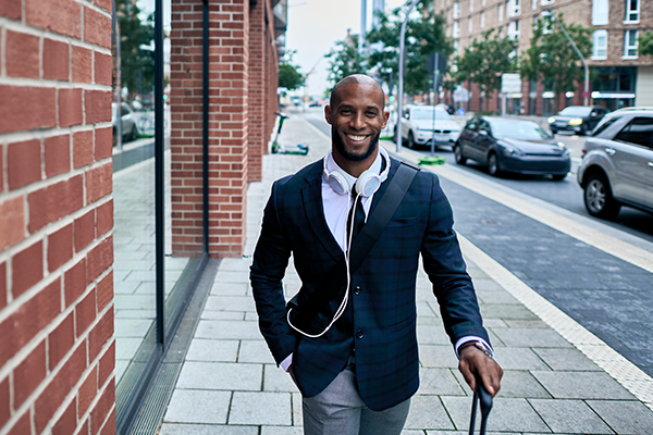 A man walking down the road enjoying his business journey