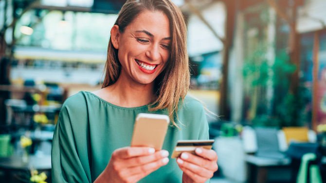 Woman smiling at phone.