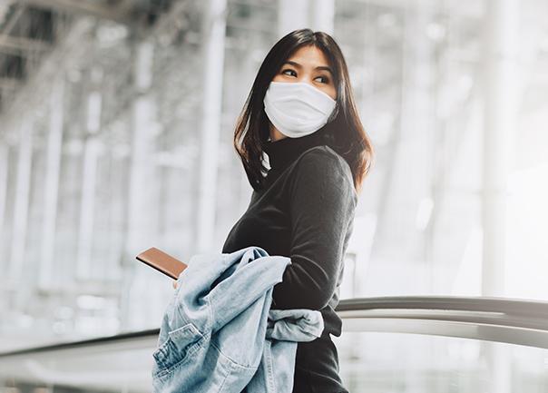 person wearing a mask in an airport