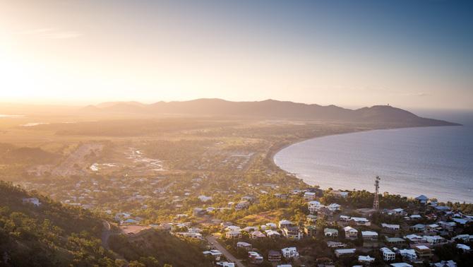 Sunset over beach coastal town from above