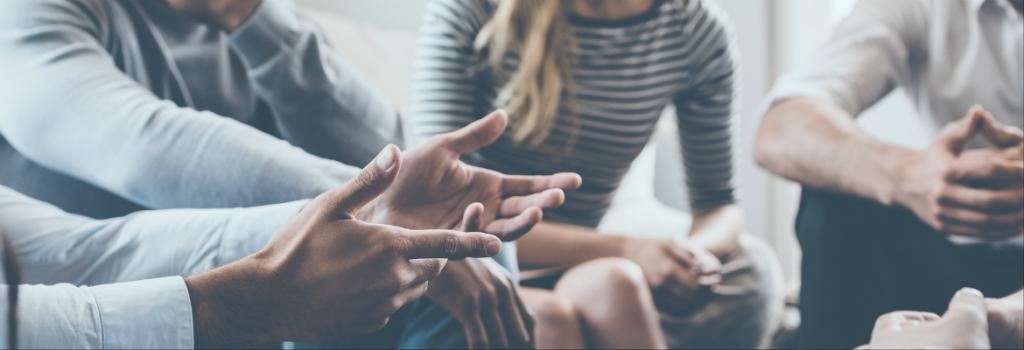 Group of people sitting in circle having a discussion