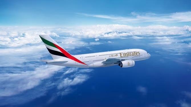 Emirates plane flying in the sky representing inflight airline entertainment. 