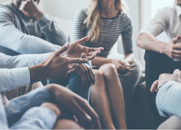 Group of people sitting in circle having a discussion