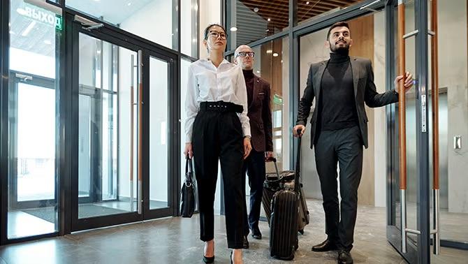 Business travellers walking into a hotel lobby representing ways to level up your travellers.