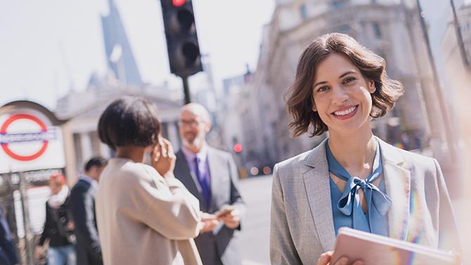 A woman navigating a busy street, showing the ease and convenience of YOUR.CT business travel tech platform