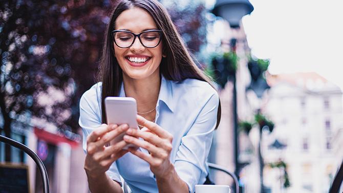 A woman using her phone, exploring YOUR.CT Powerful Tools for seamless business travel management