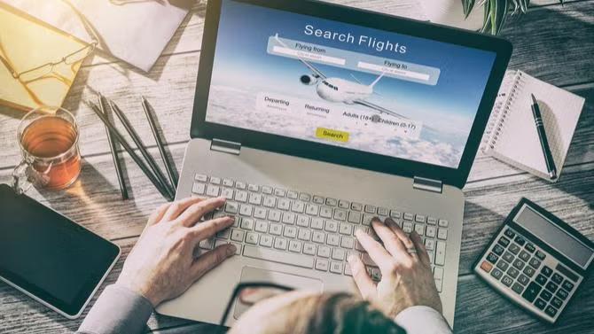 Hands on a laptop searching for flights demonstrating Expert Tips for Improving Air Travel Programs.