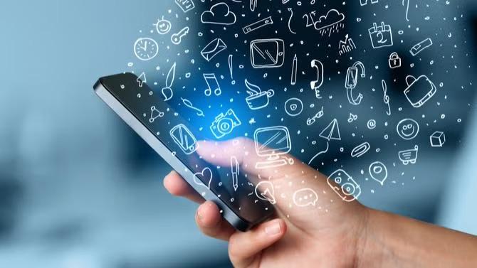 Hand holding a smartphone with graphics of images floating out of it representing a guide to AI for SMEs. 