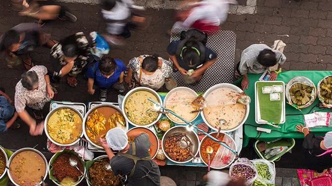 Street food vendors in Bangkok, showcasing tourist attraction in the Bangkok travel guide. 