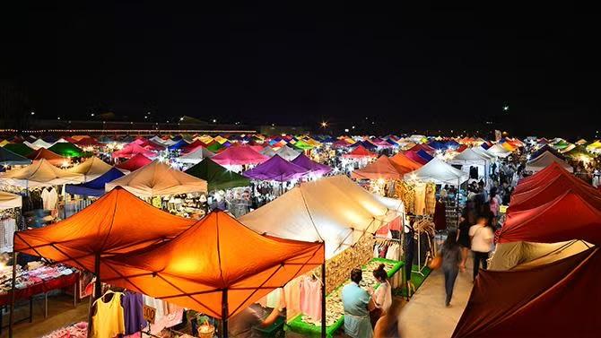 Night market scene in Bangkok, showcasing tourist attraction in the Bangkok travel guide. 