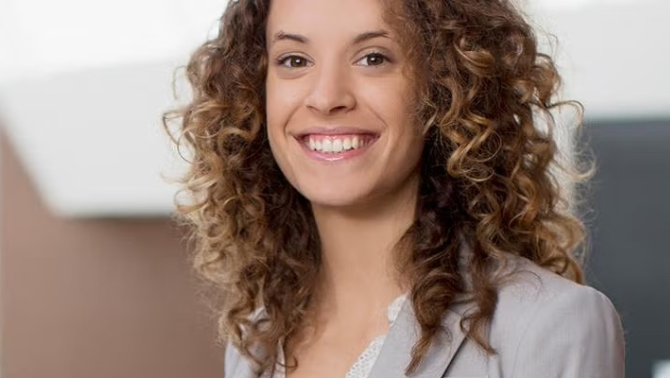 A woman smiling demonstrating how when you need to travel for business, there are a number of variables that can make your trip a productive experienc