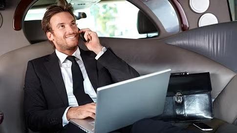 Man sitting at the back of the car representing a specific business traveller type. 