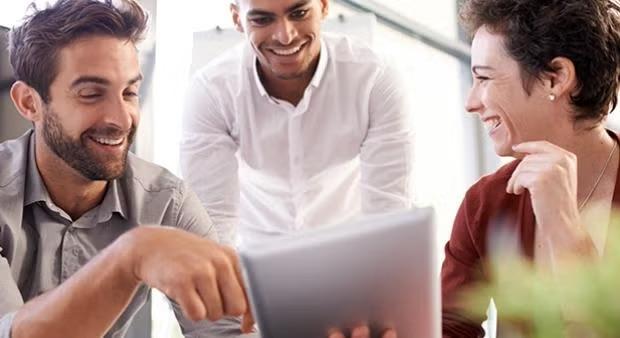 Co-workers looking at a document demonstrating why a company should never compromise on great service