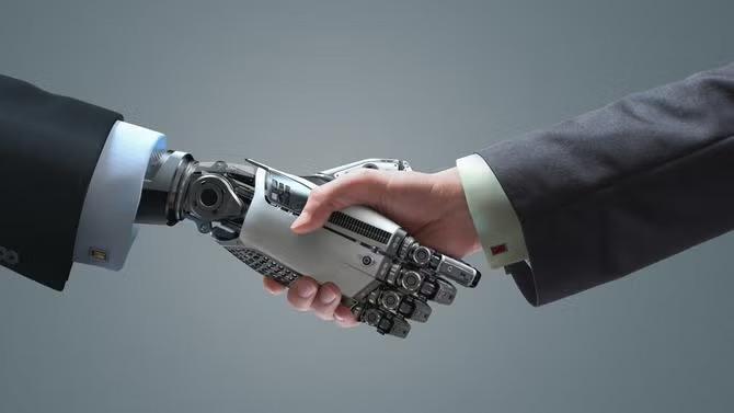 A human hand and robotic hand shaking hands representing the future of AI. 