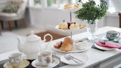Tea and pastries being served on a tray, demonstrating a business traveller's guide to London.