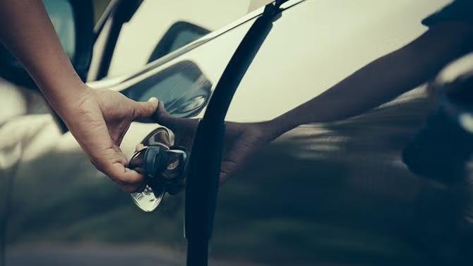A hand opening a car door, representing rental cars, showcasing tourist attractions in the Los Angeles travel guide. 