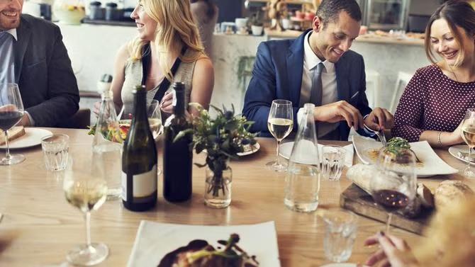 Diners sitting in a restaurant, showcasing tourist attractions in the Melbourne travel destination guide. 
