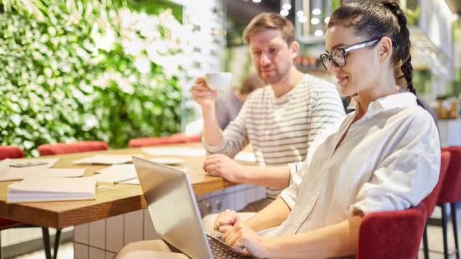 People working in a co-working space, showcasing tourist attractions in the Melbourne travel destination guide. 