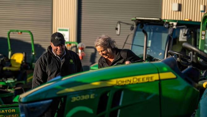 Two people inspecting farming equipment representing how RDO Equipment’s travel needs were met by the right TMC. 