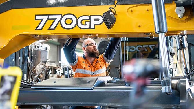 Man working on machinery representing how RDO Equipment’s travel needs were met by the right TMC. 