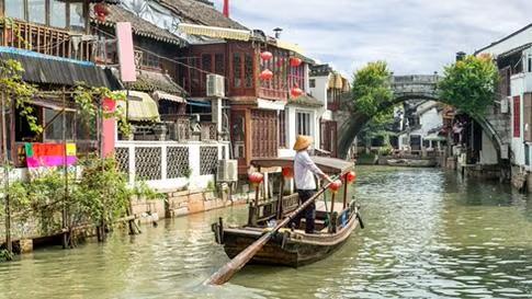Boat sailing in water, showcasing tourist attractions as part of the Shanghai destination travel guide.