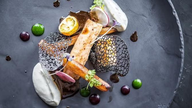 A plate of fine dining cuisine, showcasing tourist attractions in the Singapore travel destination guide. 
