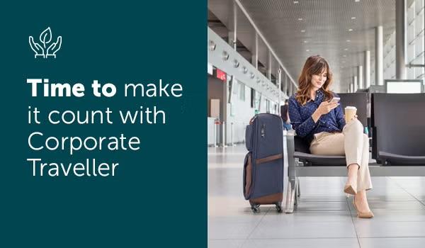 A woman sitting in the airport next to her suitcase representing the importance of sustainability in business travel.