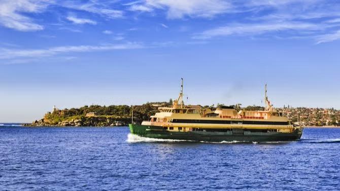 Cruise boat in the harbour showcasing tourist attractions in the Sydney travel destination guide. 